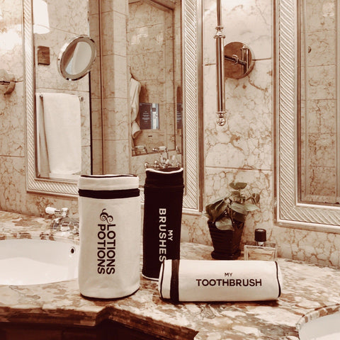 Bag-all Cream Toothbrush Travel Case displayed on marble bathroom counter with matching organizers, showcasing sleek Scandinavian design and practical storage solution