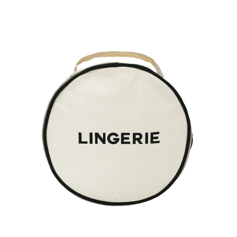 Bag-all Round Lingerie Case in cream canvas with black trim, featuring bold LINGERIE text and dual-zipper closure for organized travel storage