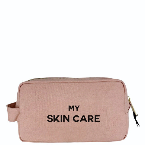 Bag-all My Skin Care Organizing Pouch in blush pink cotton with waterproof lining, featuring black text print and side handle for stylish skincare storage and travel