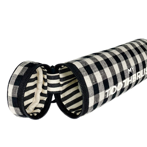 Bag-all Toothbrush Travel Case in black and white gingham pattern with zippered opening, stylish linen exterior and striped interior lining for multiple toothbrushes