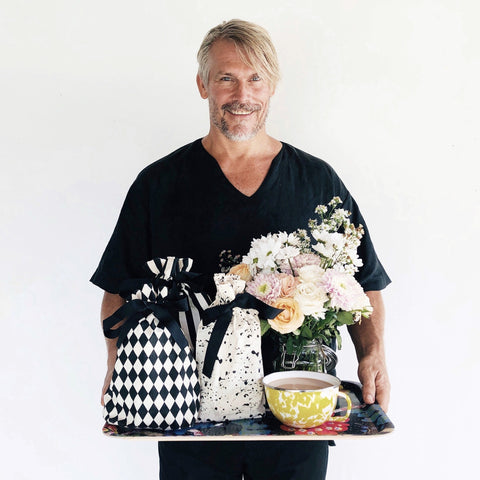 Bag-all Gift Bag Splatter Small: Eco-friendly reusable fabric gift bag with black and white splatter pattern displayed alongside floral arrangement and decorative tea cup