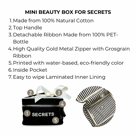 Bag-all Mini Beauty Box for Secrets in black cotton with waterproof lining, gold zipper, and detachable white bow. Features striped interior and eco-friendly construction for travel-sized items and personal keepsakes.