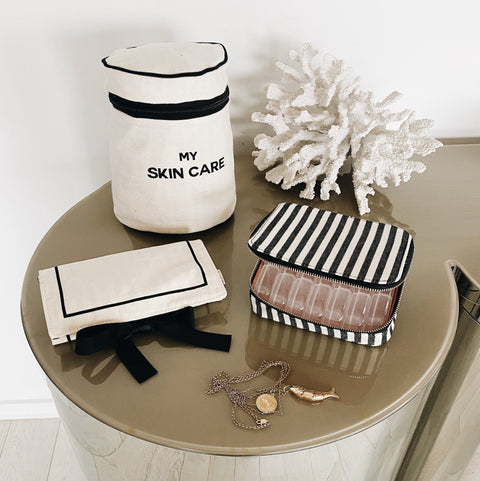 Bag-all Essential Gift Set Deal 3-Pack Cream featuring organizing cases for skincare, pills, and jewelry, displayed on round table with decorative coral, black and white cotton design with elegant stripes and bows