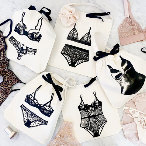 Bag-all London Lingerie Travel Bag in cream features stylish black lingerie illustrations on cotton, perfect for organizing and protecting delicate underwear while traveling or at home