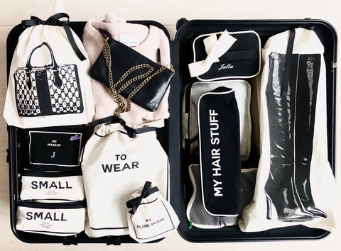 Bag-all Vintage Handbag Travel Bag in cream featuring organized storage compartments with labeled cotton bags for accessories, boots, and fashion items, displayed in a sleek black travel case
