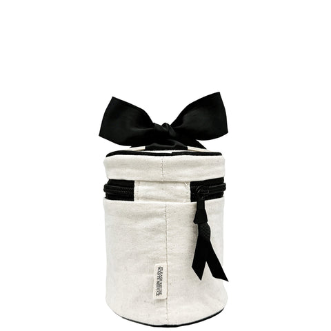 Cream round carry on liquids case with black zipper and bow, monogrammed, travel size, TSA compliant bottle set inside