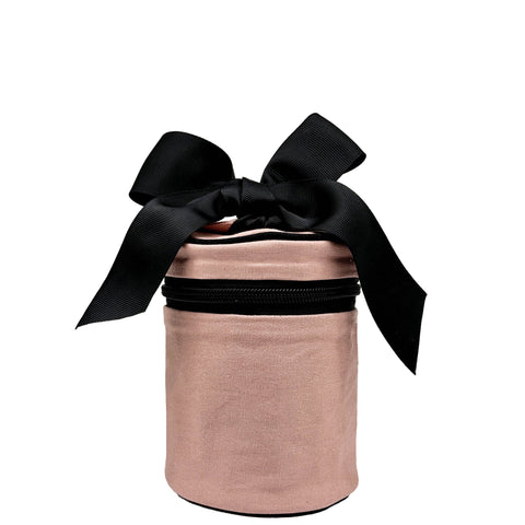Pink blush round carry on liquids case with black bow and zipper, designed for travel and organization