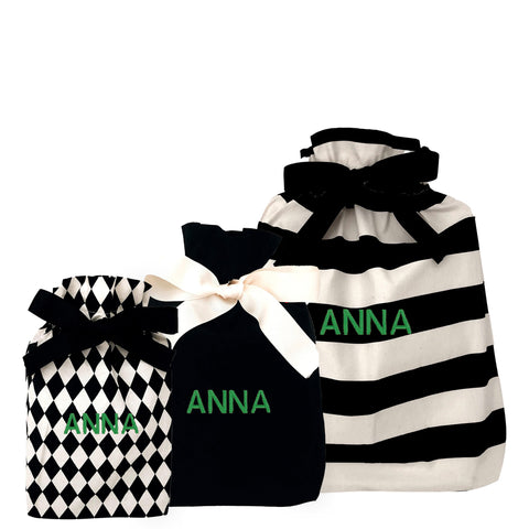 Set of three reusable fabric gift bags with personalized monogram "ANNA" in different black and white patterns