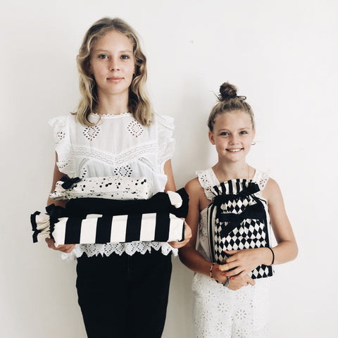 Bag-all Gift Bag Black Medium shown with coordinating striped and harlequin pattern bags, demonstrating size and style versatility against white background