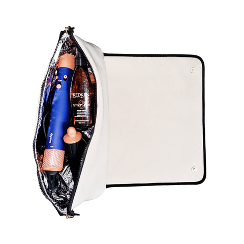 Cream hair tools travel case open showing blue hair iron and styling products inside with heat-resistant lining and elastic straps
