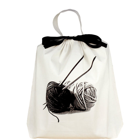 Bag-all Cream Knitting Bag with black bow and yarn ball print, featuring cotton canvas material and carrying handle for portable craft storage