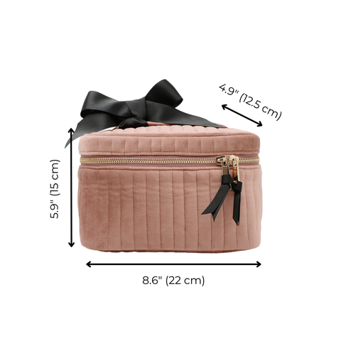 Quilted pink velvet makeup cosmetic box with black bow, gold zipper, and compact rectangular shape with measurements.