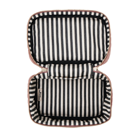 Open quilted pink velvet makeup box with black and white striped interior lining for cosmetic storage