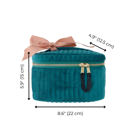 Quilted teal velvet cosmetic box with gold zipper and pink bow, measuring 8.6 by 5.9 by 4.9 inches