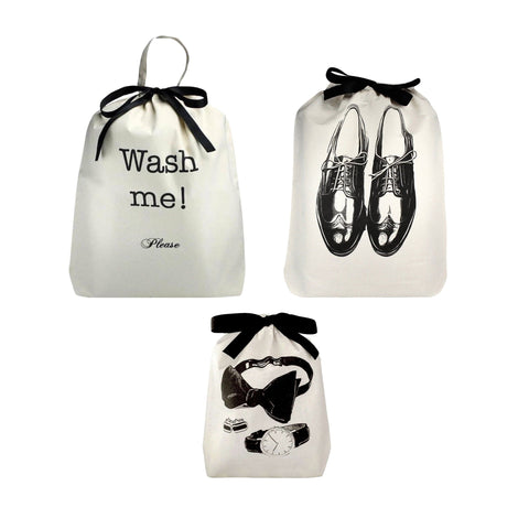 Bag-all Men's Travel Set 3-pack in cream featuring laundry bag with 'Wash me!' text, shoe bag with oxford design, and accessories bag with travel essentials illustration, all with black ribbon ties