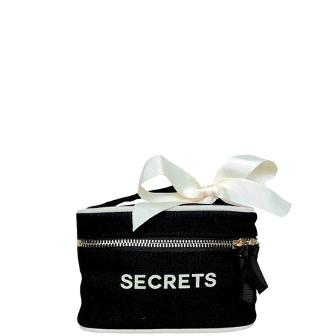 Bag-all Mini Beauty Box for Secrets in black cotton with white bow, metal zipper, and waterproof lining - perfect for storing small treasures and makeup