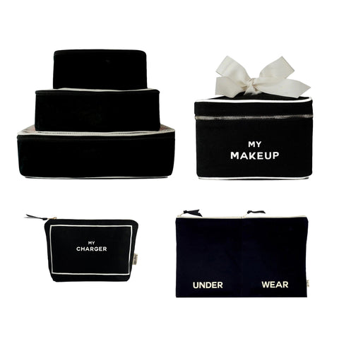 Bag-all Travel Glam 4-Pack featuring black cotton organizers with white trim - includes packing cubes, makeup box, charger pouch, and lingerie organizer for stylish travel storage