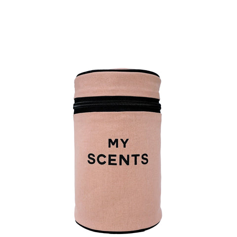 Bag-all Round My Scents Case in pink blush featuring black zipper closure and text, cylindrical perfume organizer with leak-proof lining and secure rubber bands