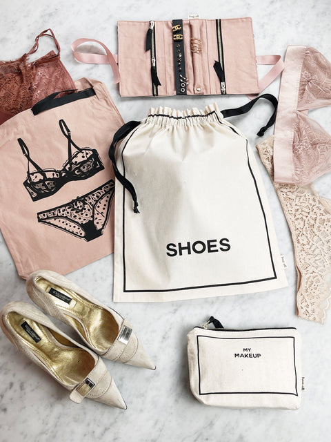 Bag-all Couture Shoe Travel Bag in cream color - elegant cotton drawstring storage bag for footwear organization with black text print and contrast ribbon ties, perfect for travel and closet storage