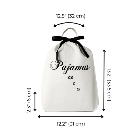 Bag-all Pajamas Zzzz Travel Bag in cream cotton with black bow, featuring elegant script text and measurements: 12.5" width, 13.2" height, drawstring closure and hanging loop