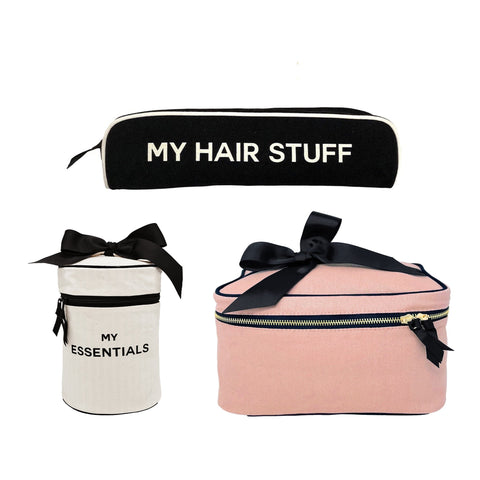 Bag-all Hair & Makeup Gift Bundle featuring black hair stuff case, white essentials case, and pink makeup bag with elegant black bows, perfect for organized beauty storage