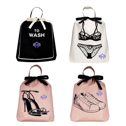 Bag-all Travel Light 4-pack for Her: Stylish organizing bags featuring laundry, lingerie, heels, and sneakers designs in black, white, and pink with monogram details and black ribbon accents