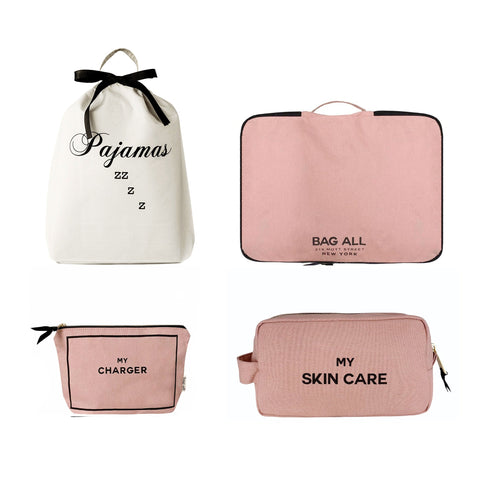 Bag-all Essentials Getaway 4-Pack featuring white pajama bag with black bow, pink packing cube, charger pouch, and skincare organizer in blush pink cotton