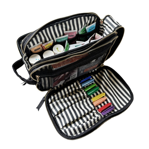 Cream triple travel and hobby organizer open to show compartments with pens, tubes, and bottles inside