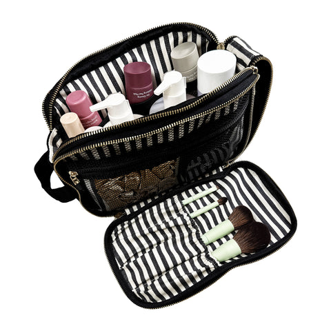 Black triple beauty and toiletry organizer with striped interior, mesh pockets, and makeup brushes displayed inside