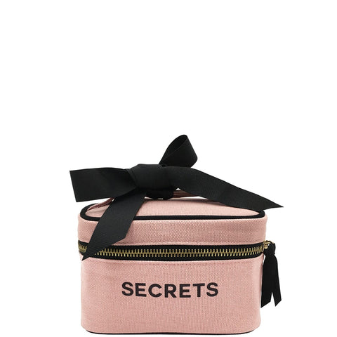 Bag-all Mini Beauty Box for Secrets in blush pink cotton with black bow, double zippers, handle and signature print, perfect for cosmetics and travel essentials